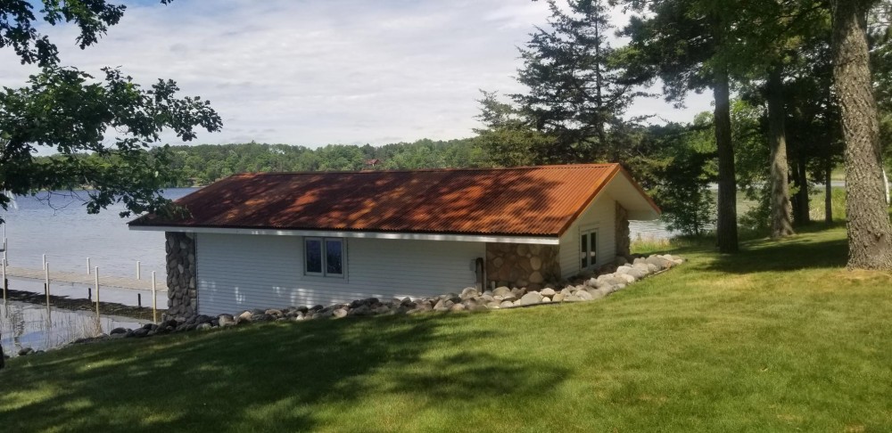 Photo By Allstar Construction. Corten Steel Corrugated Metal Roof On Boat House