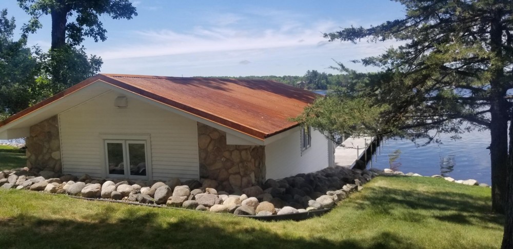 Photo By Allstar Construction. Corten Steel Corrugated Metal Roof On Boat House