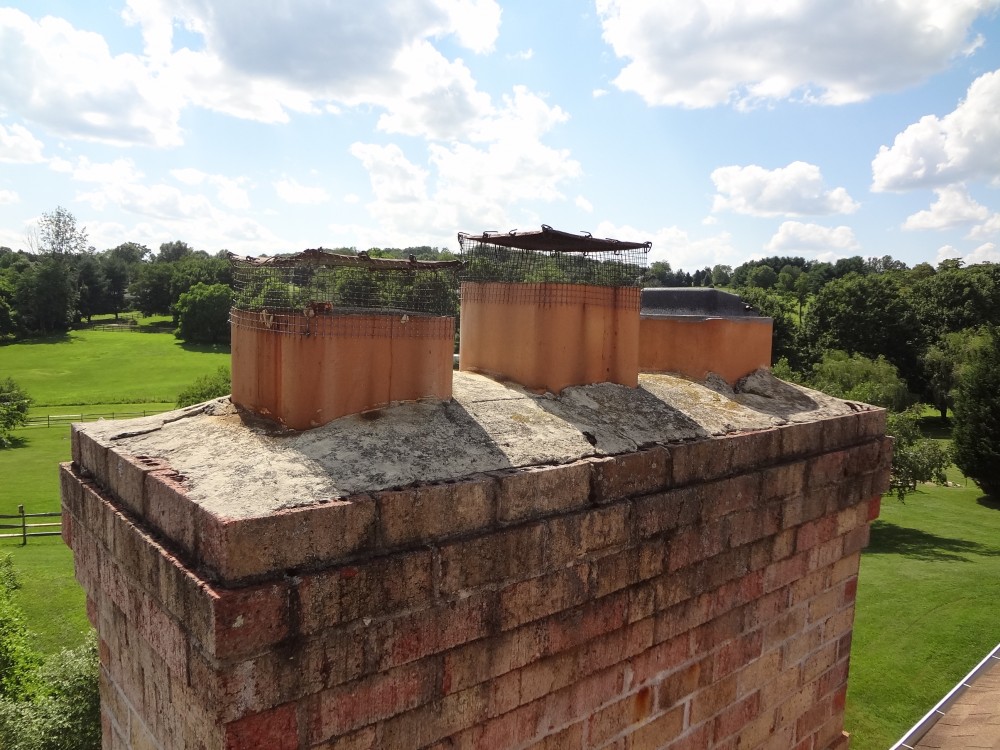 Photo By BRAX Roofing. Chimney Crown.