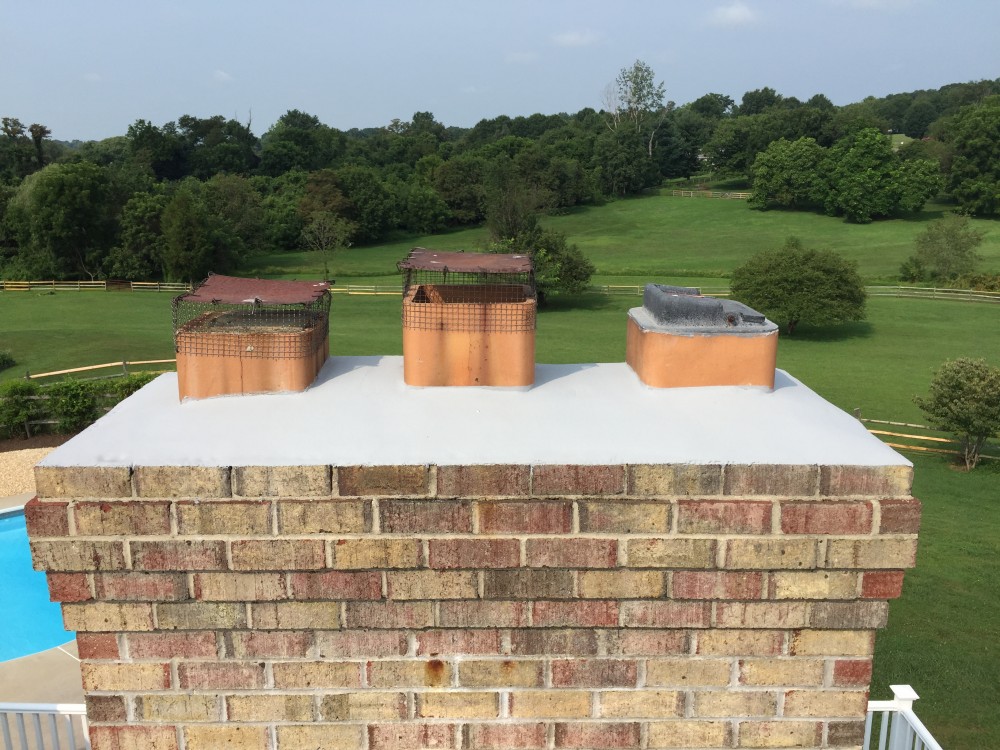 Photo By BRAX Roofing. Chimney Crown.