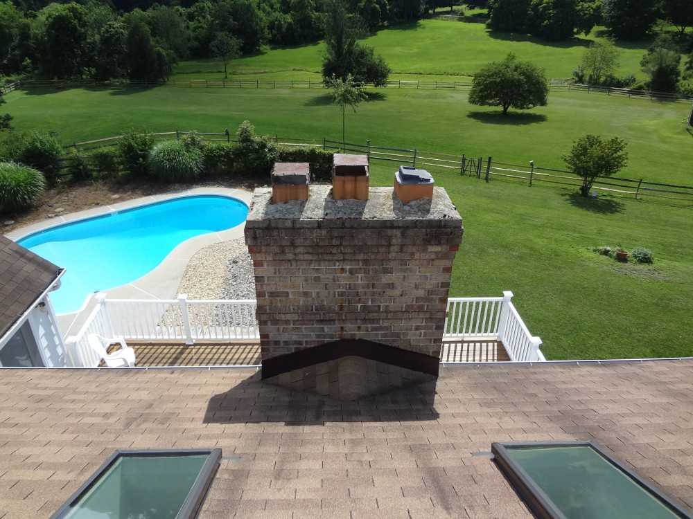 Photo By BRAX Roofing. Chimney Crown.