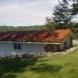 Photo by Allstar Construction. Corten steel corrugated metal roof on boat house - thumbnail