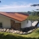 Photo by Allstar Construction. Corten steel corrugated metal roof on boat house - thumbnail