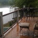 Photo by All American Exteriors. Timbertech Decking, Rails, Stone & Cedar Columns - thumbnail